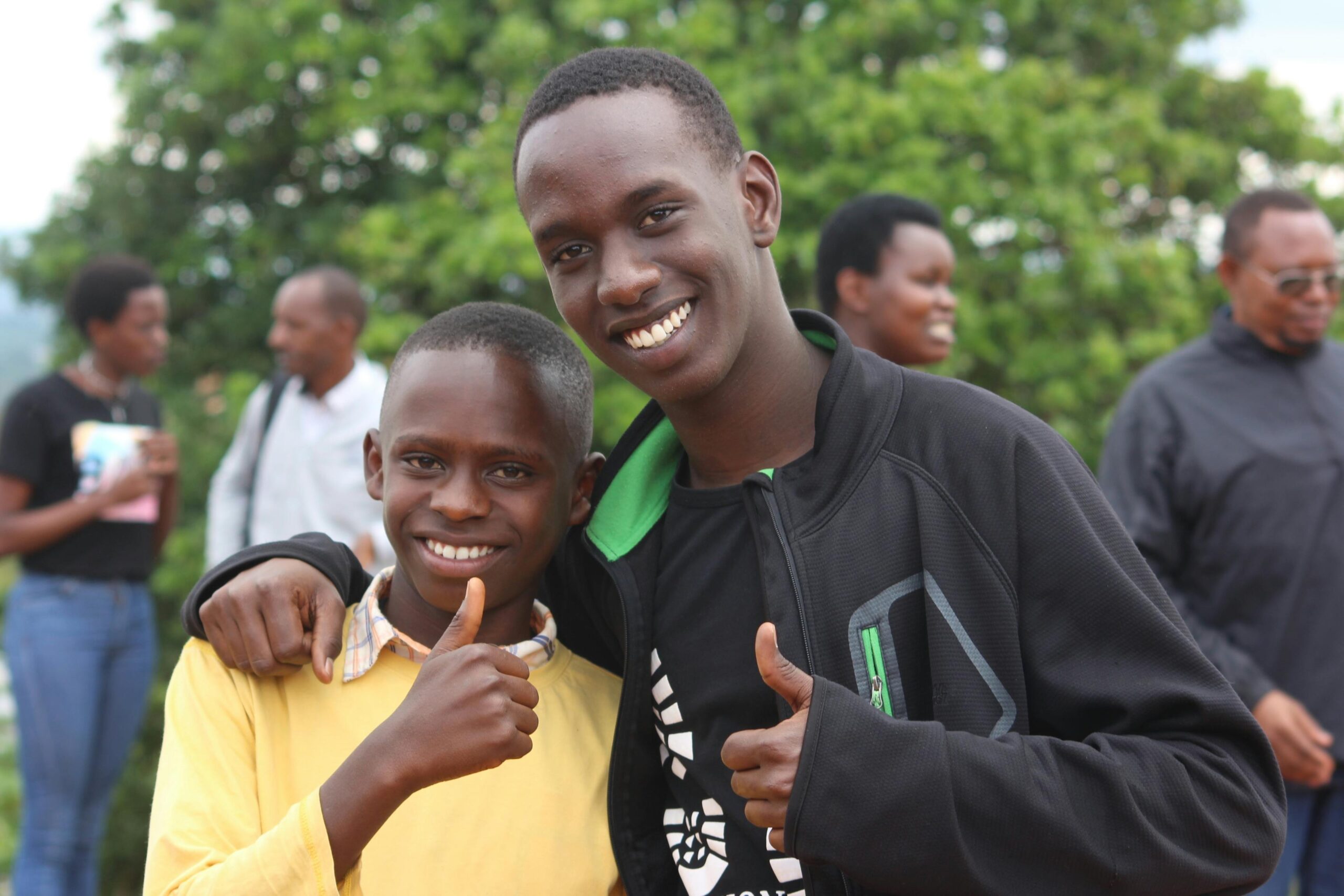 Black teenager hand around young black kid