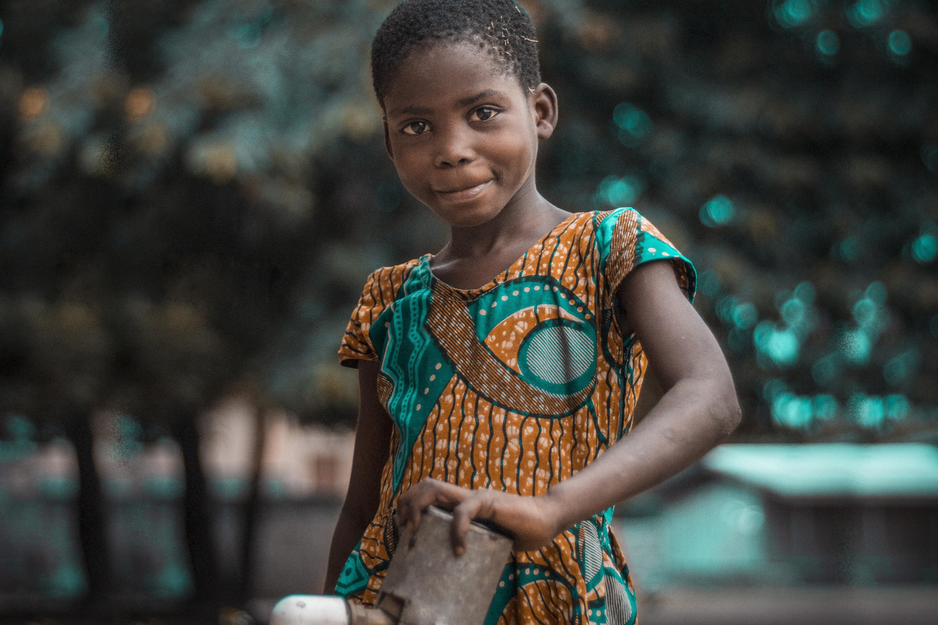 Young african girl holding object posing
